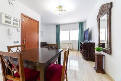 a dining room with a table and chairs and a mirror at Mar & Cunit in Cunit