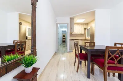 a dining room with a table and a mirror at Mar & Cunit in Cunit