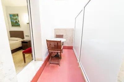 a room with a mirror and a chair and a table at Mar & Cunit in Cunit