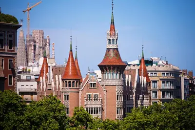 a group of tall buildings with towers in a city at Sweett - Casa Palau in Barcelona