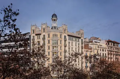 a large building with a tower on top of it at Sweett - Casa Palau in Barcelona