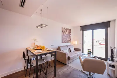 a living room with a table and a couch at Sweett - Casa Palau in Barcelona