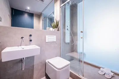a bathroom with a toilet and a sink and a shower at Sweett - Casa Palau in Barcelona