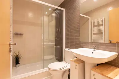 a bathroom with a toilet and a sink and a shower at El Capricho Terrassa. in Terrassa