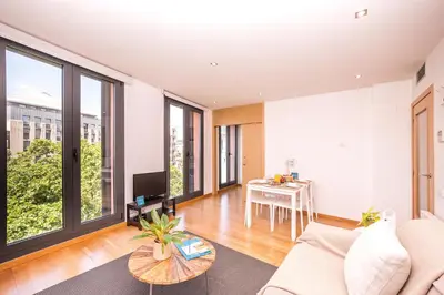 a living room with a couch and a table at Sweett - Jardinets in Barcelona