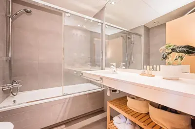 a bathroom with a tub and a sink and a shower at Sweett - Jardinets in Barcelona