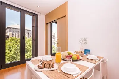 a dining room with a table with food on it at Sweett - Jardinets in Barcelona