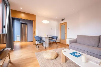 a living room with a couch and a table at Sweett - Jardinets in Barcelona
