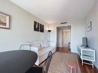 a living room with a white couch and a tv at Stay U-nique Apartments Sants II in Barcelona