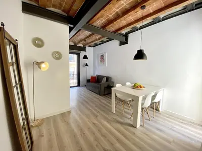 a living room with a white table and chairs at Sants Montjuic Olympic View in Barcelona