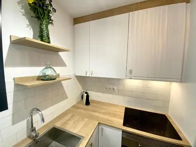 a kitchen with white cabinets and a sink at Sants Montjuic Olympic View in Barcelona