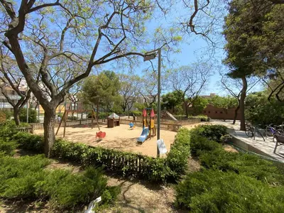 a playground with a slide in a park at Sants Montjuic Olympic View in Barcelona