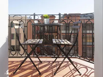 a table and two chairs on a balcony at Sunny Playa Apartment in Barcelona