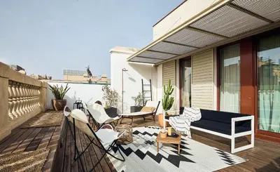 a patio with chairs and a table on a porch at TAKLA - Two bedroom apartment in Diputación St in Barcelona