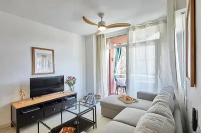 a living room with a couch and a tv at BBarcelona Modern Eixample Flat in Barcelona