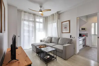 a living room with a couch and a tv at BBarcelona Modern Eixample Flat in Barcelona