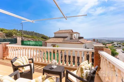 a living room with a white couch and a fireplace at Charming Spanish Villa private pool / Sea views in Sitges