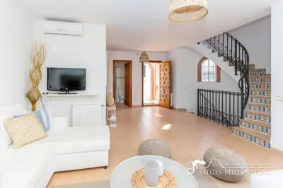 two beds in a white room with a window at Charming Spanish Villa private pool / Sea views in Sitges