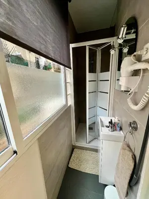 a small bathroom with a sink and a window at Poble Sec. Excelente ubicación cerca de la playa y de las Ramblas in Barcelona