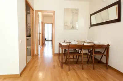 a dining room with a table and some chairs at Penthouse Vallespir in Barcelona