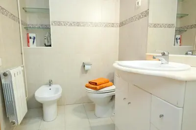 a white bathroom with a sink and a toilet at Penthouse Vallespir in Barcelona