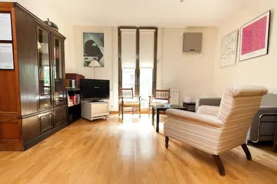 a living room with a couch and a chair at Penthouse Vallespir in Barcelona
