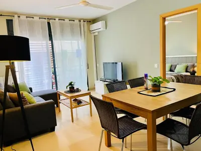 a living room with a table and a couch at Magic Camp Nou in Barcelona