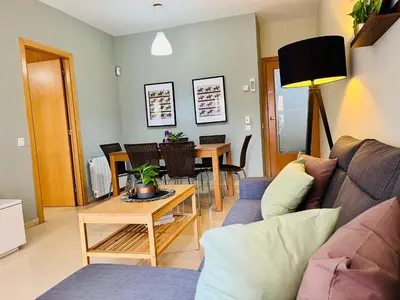 a living room with a couch and a table at Magic Camp Nou in Barcelona