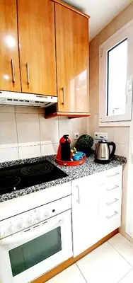 a kitchen with a stove and a stove top oven at Magic Camp Nou in Barcelona