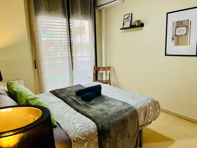 a room with a bed with a blue pillow on it at Magic Camp Nou in Barcelona
