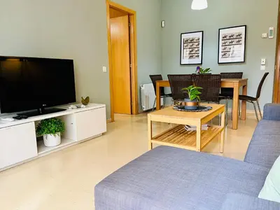 a living room with a couch and a tv at Magic Camp Nou in Barcelona