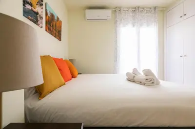 a bedroom with a white bed with towels on it at Be Barcelona Eixample Urquinaona II in Barcelona