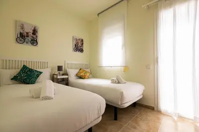 a bedroom with two beds and a window at Be Barcelona Eixample Urquinaona II in Barcelona