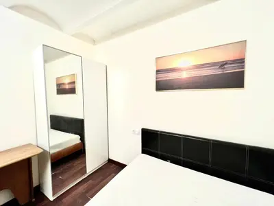 a small bedroom with a mirror and a bed at Nice apartment close PARK GÜELL 2 in Barcelona