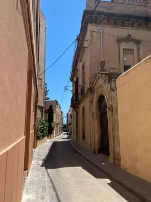 an empty street in an old building with an archway at Luminoso apartamento en Canet de Mar cercano a la playa y a Barcelona in Canet de Mar