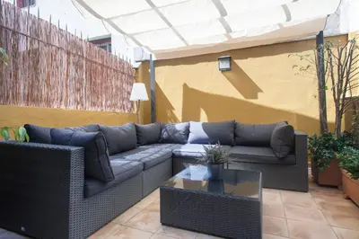 a patio with a couch and a table at Habitat Apartments Ferran in Barcelona