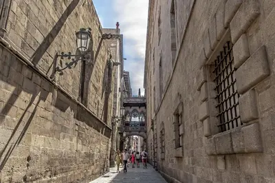 a group of people walking down a street with a bridge at Habitat Apartments Ferran in Barcelona