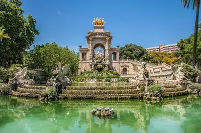 a building with a fountain in the middle of the water at Habitat Apartments Born in Barcelona