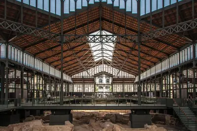 a large building with a wooden ceiling and a bridge at Habitat Apartments Born in Barcelona