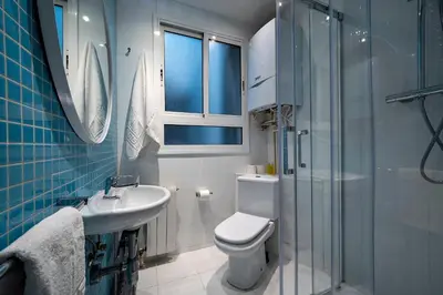 a bathroom with a toilet and a sink and a shower at Habitat Apartments Art in Barcelona
