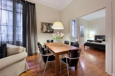a living room with a table and chairs and a couch at Habitat Apartments Art in Barcelona