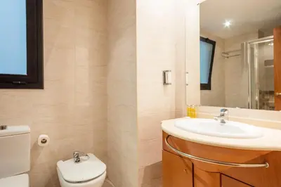 a bathroom with a sink and a toilet at Habitat Apartments Carders in Barcelona