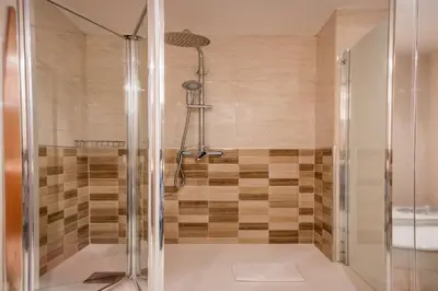 a shower with a glass door in a bathroom at Habitat Apartments Carders in Barcelona