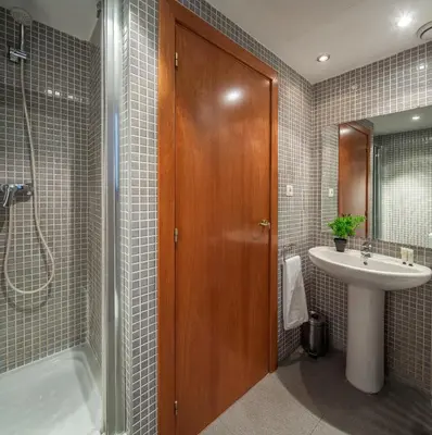 a bathroom with a shower and a sink and a tub at Habitat Apartments Carders in Barcelona