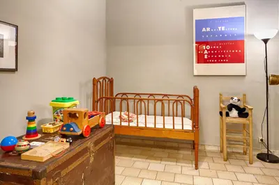 a childs room with a bed and a table with toys at Habitat apartments Barcelona Center in Barcelona