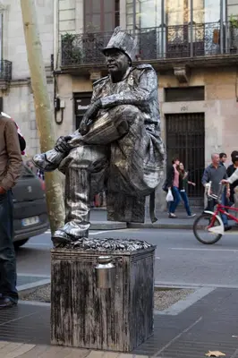 a statue of a man sitting on a stump at Habitat apartments Barcelona Center in Barcelona
