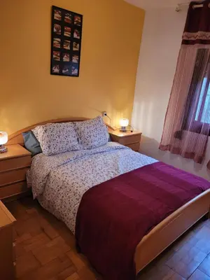 a bedroom with a bed and two night stands at Cal Jamila in Cubelles