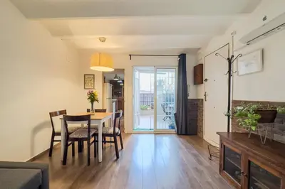 a dining room and living room with a table and chairs at Cozy Place next to Park Güell in Barcelona