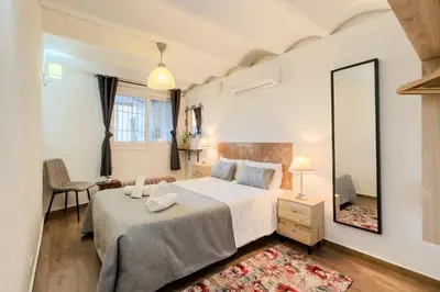 a bedroom with a large bed and a mirror at Cozy Place next to Park Güell in Barcelona