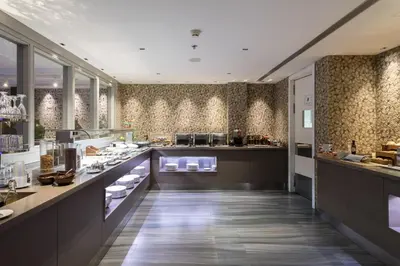 a table with a tray of food with desserts and candles at Catalonia Square 4* Sup in Barcelona